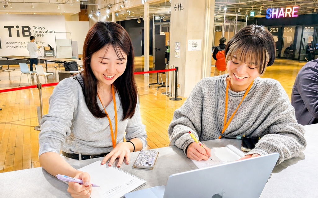 パソコンを使いながら教育サービスについて話し合うスタッフ